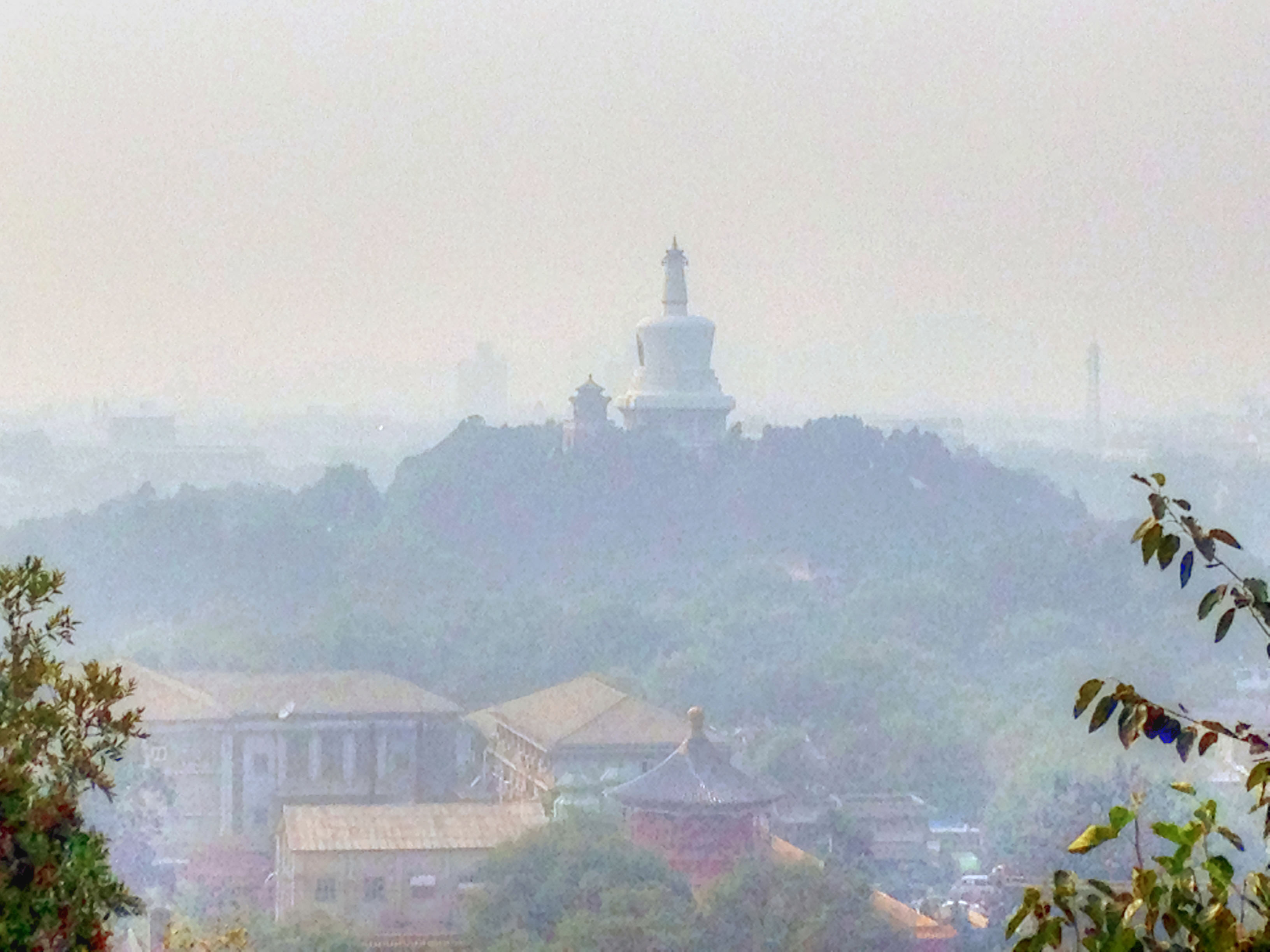 Smog obscuring the view of the white pagoda in Beijing, China. 