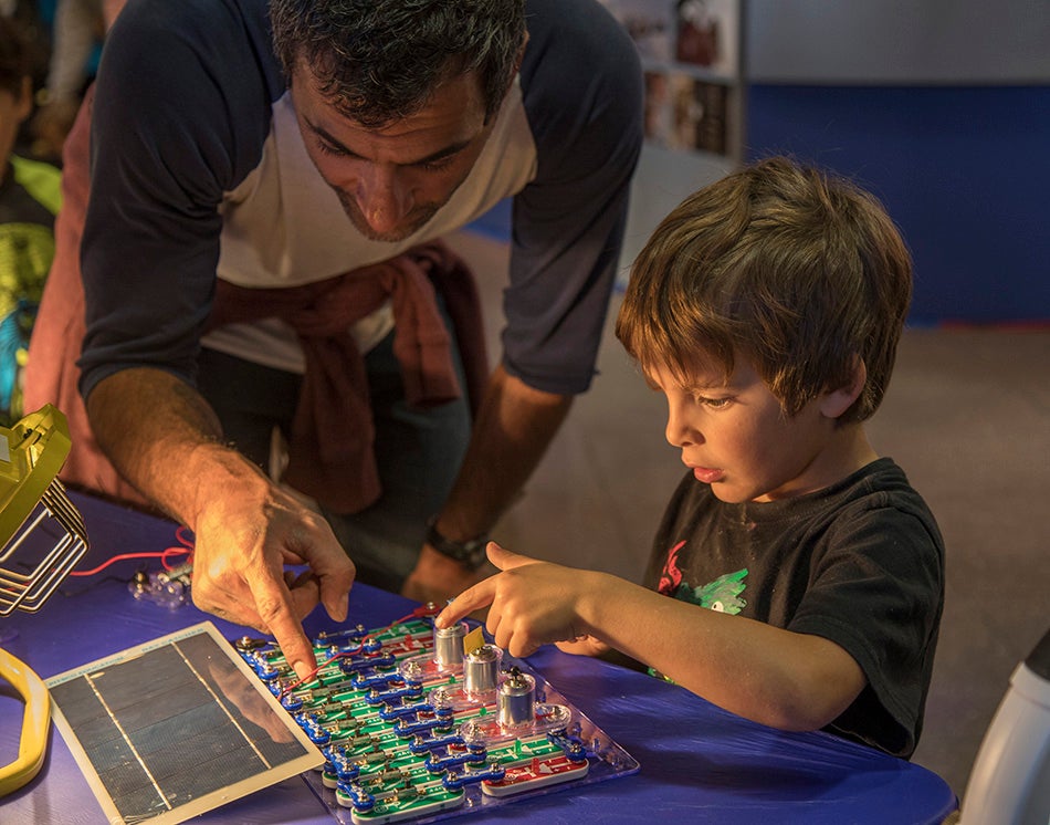 A child enjoys an activity at Super Science Saturday 