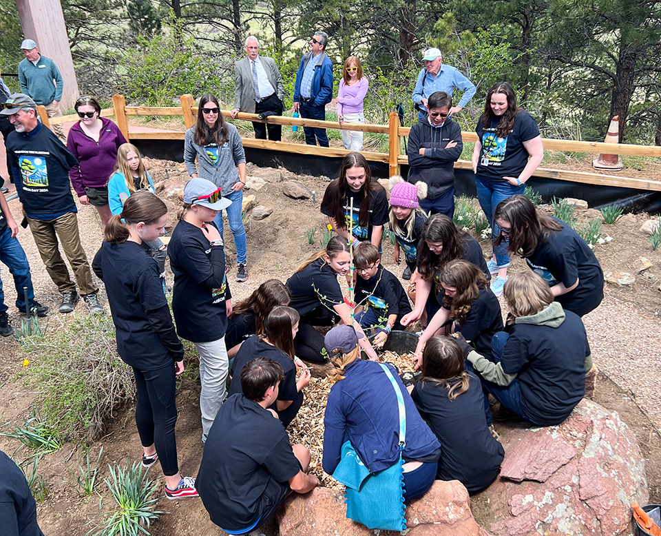 A group of students from St. Vrain Valley School District plant a second generation Moon Tree at the NSF NCAR Mesa Lab.