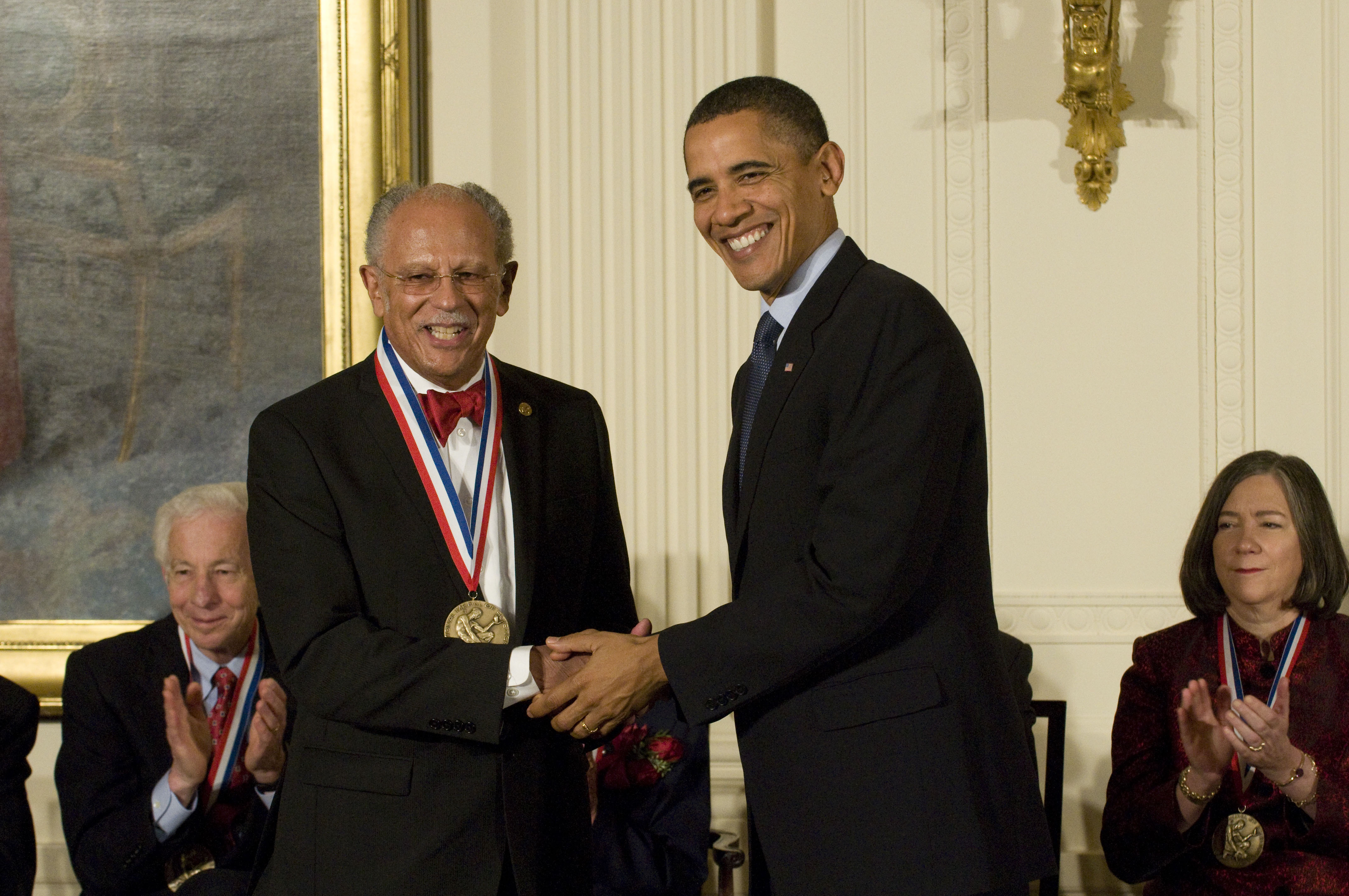 Warren Washington shaking hands with Barack Obama. 