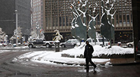 Man walking on snowy city street