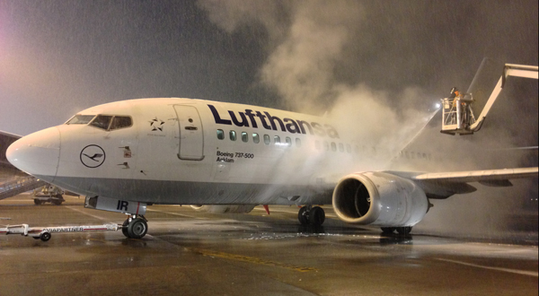 Picture of a plane getting deiced on the runway