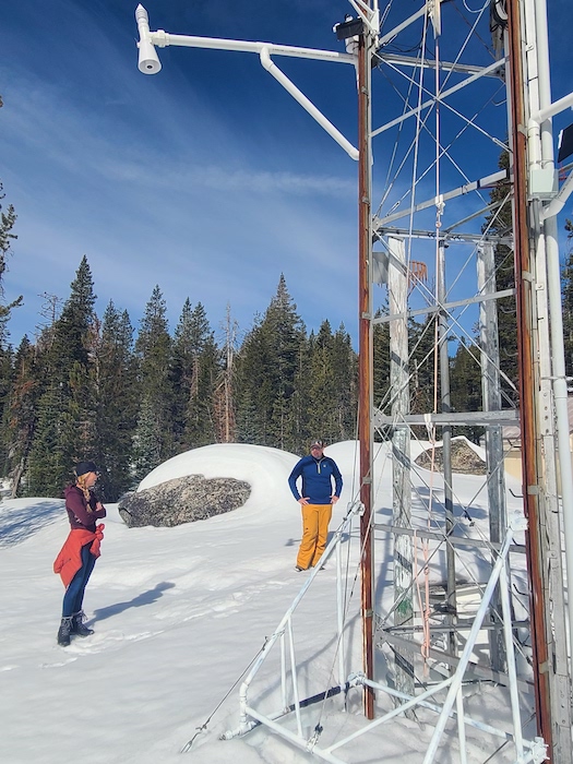 3D-PAWS testing partners Anne Heggli and Andrew Schwartz stand by a weather station fitted with a snow sensor.