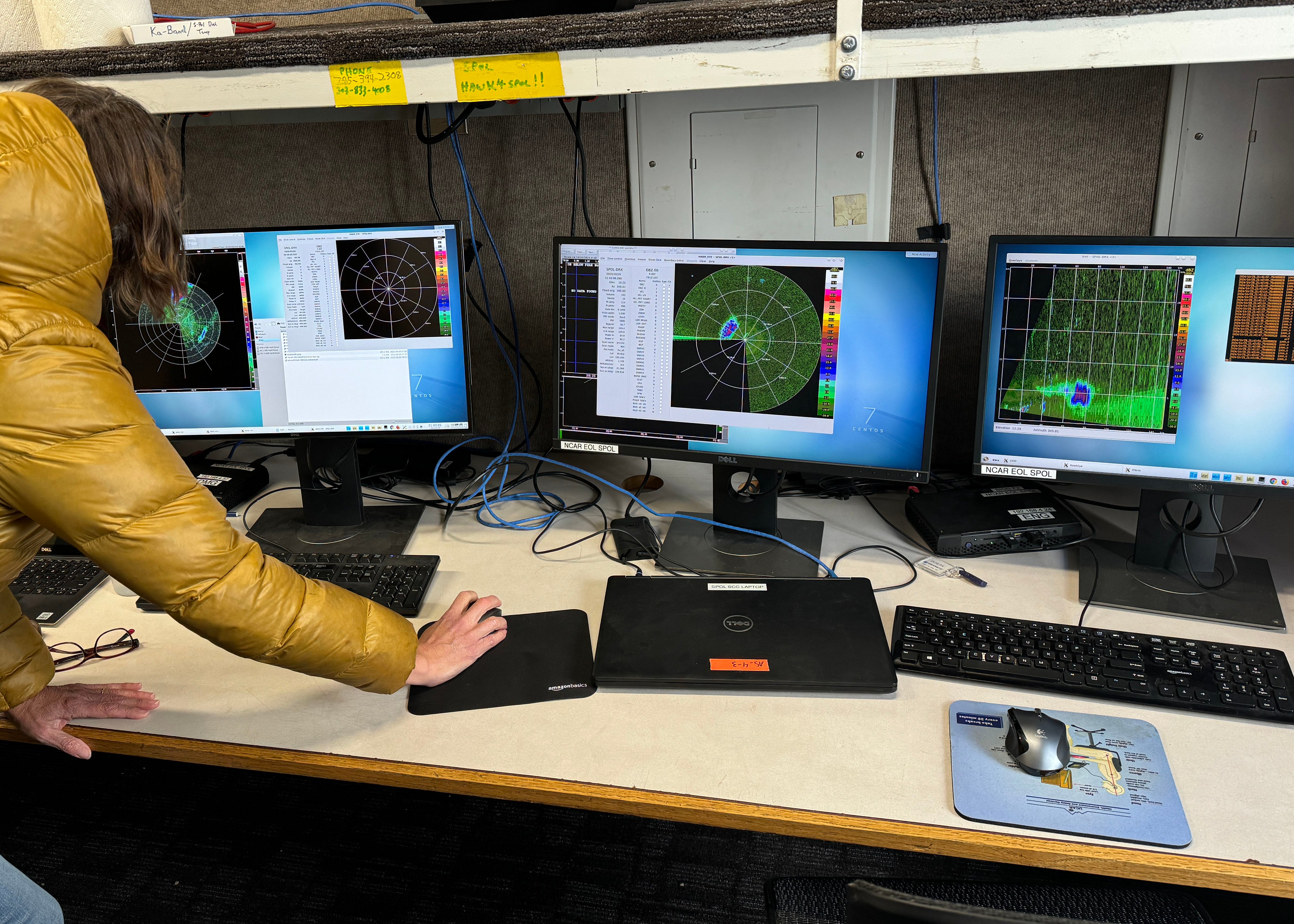 Scientist looks at three monitors displaying data from the LOTOS node.