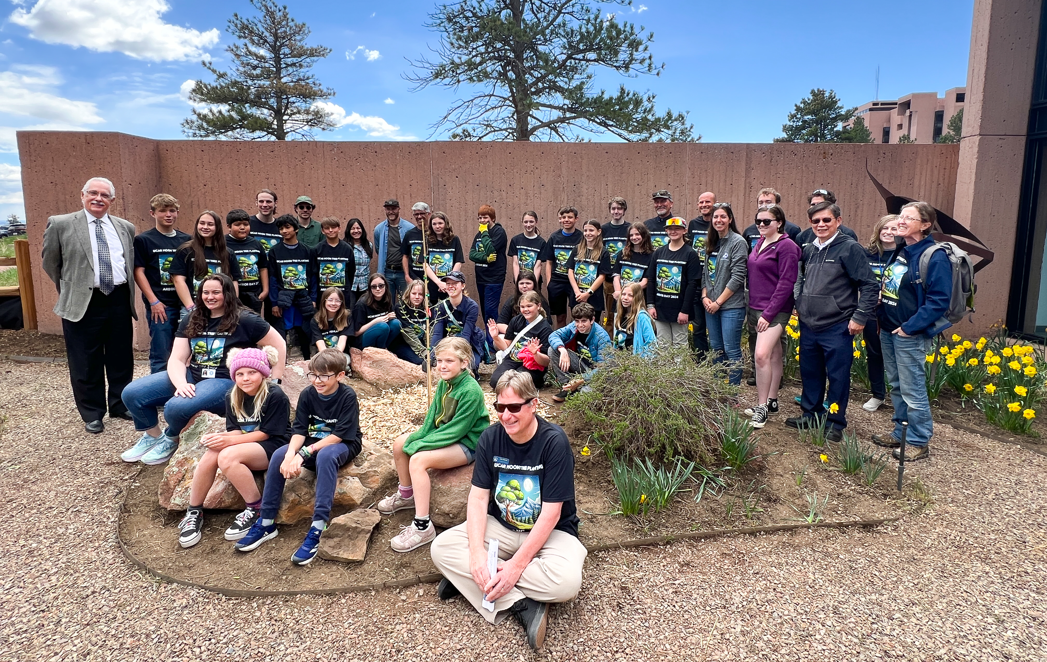Students, teachers, and NSF NCAR staff pose with the Moon Tree Descendant