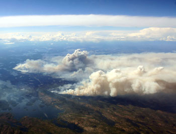 Photograph of a large smoke plume in the distance