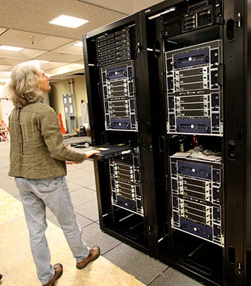 Woman looking at very large super computer