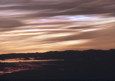 Photograph of a sunset sky, dark pink and salmon colored