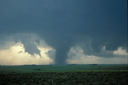 Photograph of a tornado touching down on farmland