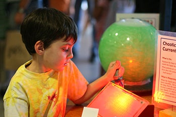 Boy looking at science exhibit