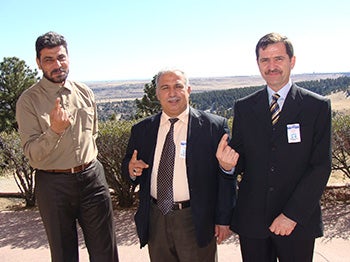 Iraqi visitors show their voting fingers