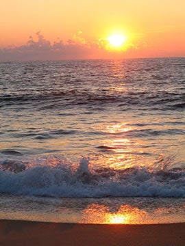 Photograph of a sunrise over the ocean