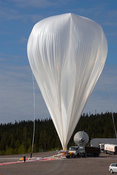 Very large white balloon being filled with helium