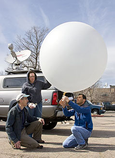 Photograph of William Brown, Jennifer Standridge, and Tim Lim with weather balloon