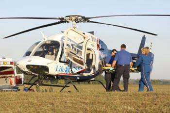 An emergency helicopter with ground crew