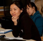 Photo of two women sitting at a lecture