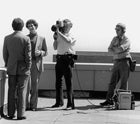 photo of a group of men, one with film camera