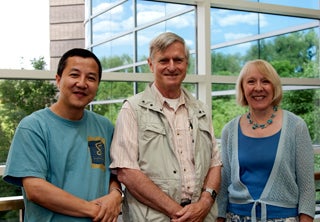 Photo of two men and one woman