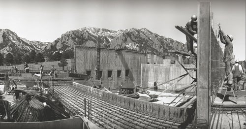 Construction of a building against foothills background