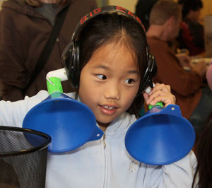 Young girl tries out "big ears" headphones
