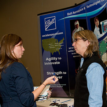 Two women discuss job possibilities at Veterans Job Fair