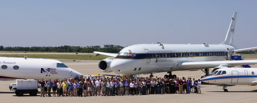 Group photo of DC3 staff with the three primary aircraft on the Salina, KS, airport runway