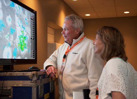 Steven Rutledge and Mary Barth view a display showing thunderstorms on radar during DC3