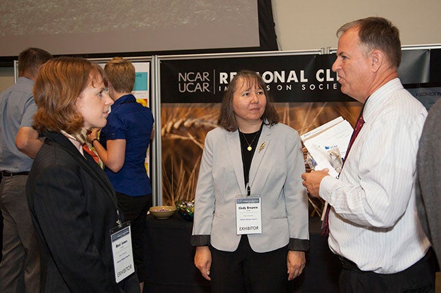 Mari Jones, Cindy Bruyere (NESL/MMM) meet with Industry Summit attendee