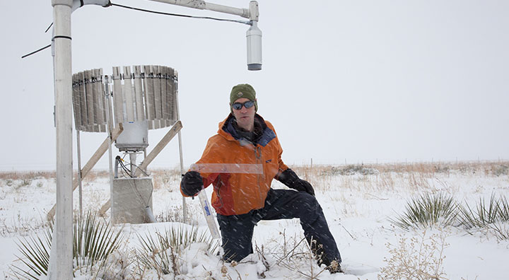 Ethan Gutmann checks automated snow measuring technology