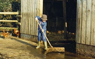 Mari Tye working on her grandfather's farm as a child.