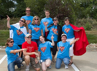 COMET staff in Superman costumes.
