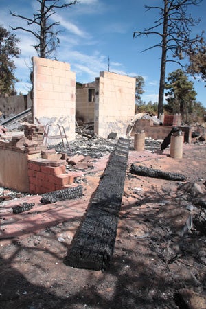 A burned down house with the foundation showing.