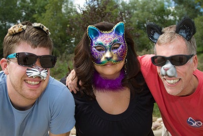 Three staff members dressed in cat outfits.