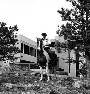 Gary Aitken on a horse outside the Mesa Lab.