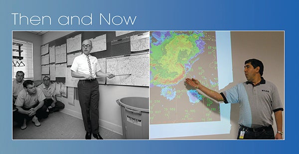 Two weathercasters side by side, one with wall maps and the other with a color display.