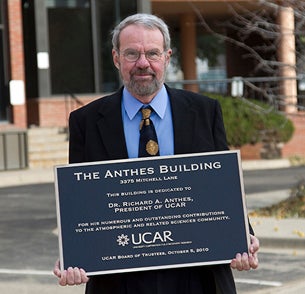 Rick Anthes holding plaque outside the Anthes Building.