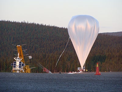 A large white balloon ascending into the sky.