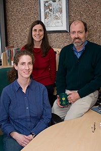 Three people sitting in an office.