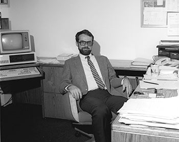 Rick sitting at his desk.