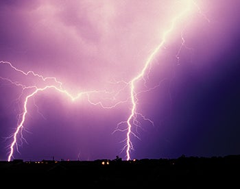 Lightning strikes in night sky