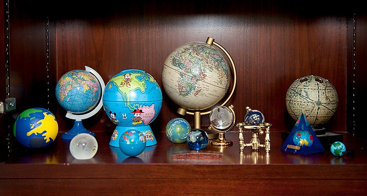 A collection of globes on a shelf.