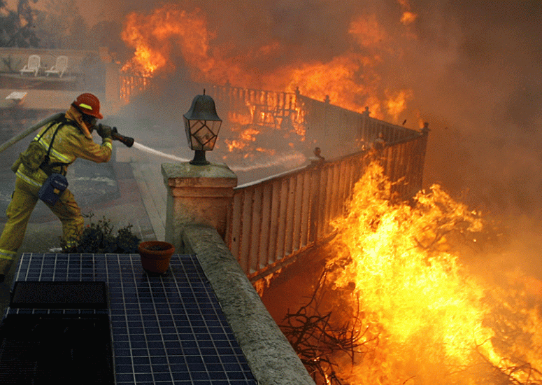 A firefighter battles flames during the September 2012 Shockey wildland fire near San Diego.