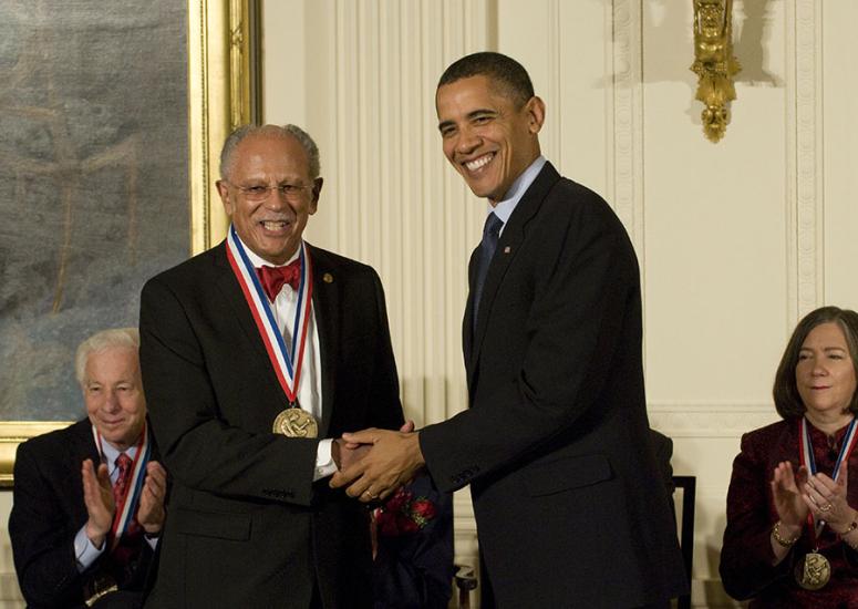 Warren Washington shaking hands with Barack Obama. 