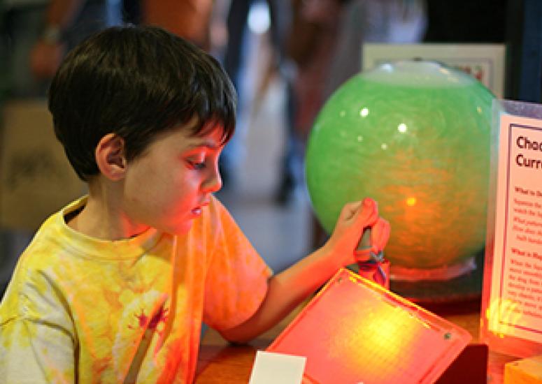Boy looking at science exhibit