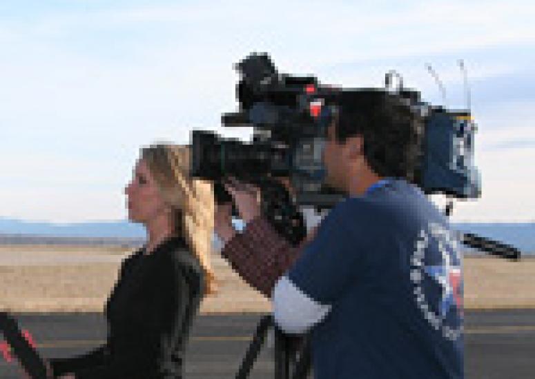 Photograph of reporter and cameraman