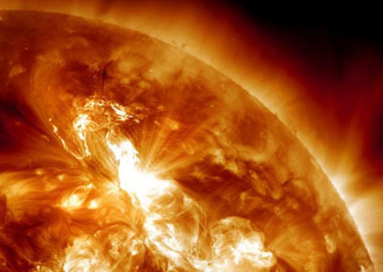 An image of the Sun with orange flares.