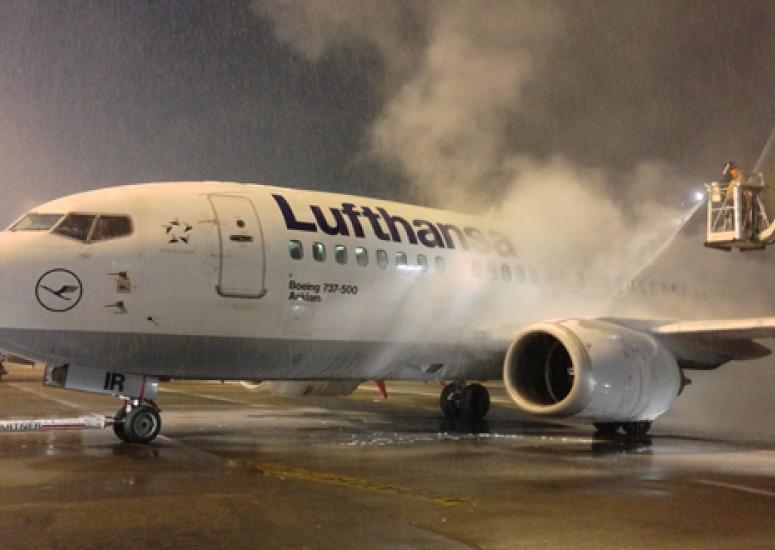 Picture of a plane getting deiced on the runway