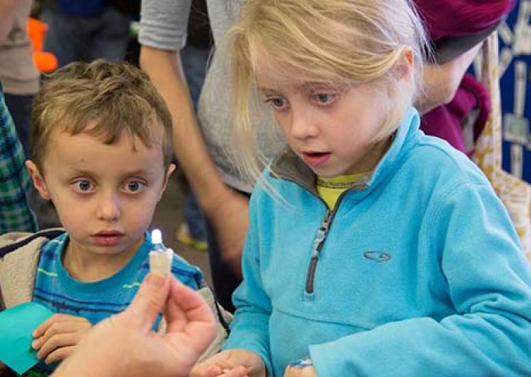 Children looking at light at Super Science Saturday in 2015.