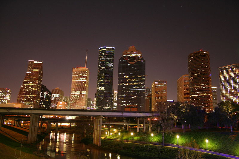 Downtown Houston skyline at night, with bayou in foreground