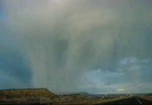 Rainshaft from cumulonimbus cloud descending near highway